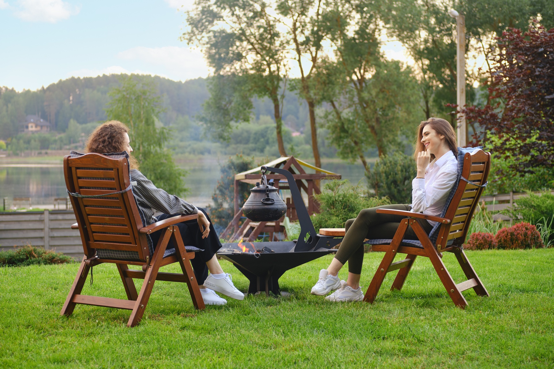 Zwei Frauen im Garten mit Feuerstelle | mobile Heizgeräte